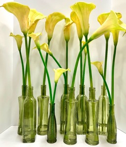 lot 435 image: 10 Yellow Calla Lilies in Green Glass Bottles - Floral Centerpiece