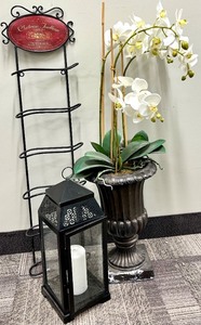 lot 453 image: Black Wrought Iron Wine Rack, Faux Potted Orchid Plant & Glass Lantern with Candle