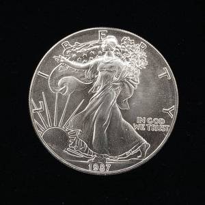 lot 247 image: 1987 Silver Eagle - 99.9% pure silver� One Troy Ounce  - Like new uncirculated TAX EXEMPT � Bright and detailed