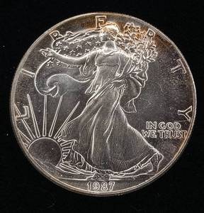 lot 216 image: 1987 Silver Eagle - 99.9% pure silver� One Troy Ounce  - Like new uncirculated TAX EXEMPT � Bright and detailed