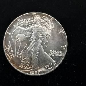 lot 228 image: 1987 Silver Eagle - 99.9% pure silver� One Troy Ounce  - Like new uncirculated TAX EXEMPT � Bright and detailed