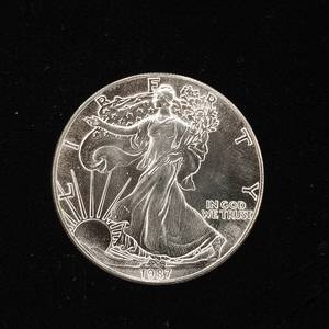 lot 249 image: 1987 Silver Eagle - 99.9% pure silver� One Troy Ounce  - Like new uncirculated TAX EXEMPT � Bright and detailed