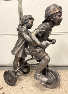 lot 59 image: Life Size Boy &amp Girl On a Tricycle Faux Bronze  Resin Garden Statue