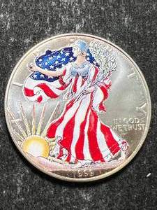 lot 25 image: 1999 AMERICAN SILVER EAGLE 1 TROY OZ .999 FINE SILVER IN COLOR