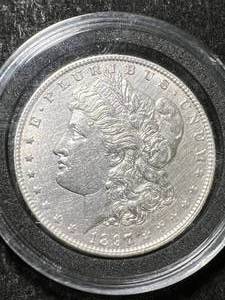 lot 31 image: 1897 US MORGAN SILVER DOLLAR IN AIRTITE