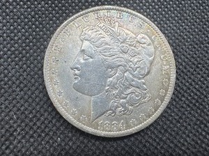 lot 24 image: 1884-O Morgan Silver Dollar