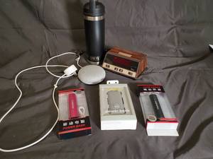 lot 47 image: YETI Bottle  3-4 Power Banks  Wooden Clock Radio  Round Speaker - Lot
