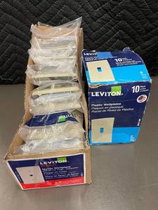 lot 79 image: Box of 10 Leviton Ivory Nylon Midway Wallplates and box of Plastic wallplates.