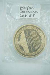 lot 5 image: 24K Gold-Plated Mayan Calendar Commemorative Coin. Clear Plastic Case