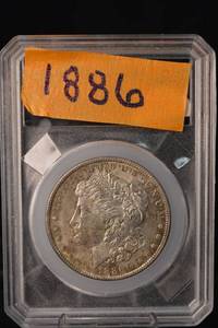 lot 11 image: Morgan Silver Dollar - 1886 United States One Dollar in Slab (Higher Grade)