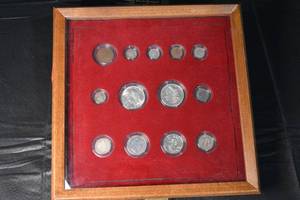 lot 52 image: 1921 Morgan Silver Dollar & Assorted US Coins in Red Felt Display Frame