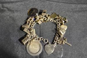 lot 124 image: Vintage Sterling Silver Charm Bracelet with Hearts, Cross & U.S. Flag Charms