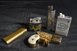 lot 137 image: Assorted Vintage Lighters - Modern Angel Pearl-Grip Gun Lighter, Dragon Brass Lighter