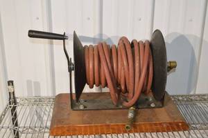 lot 269 image: Hose Reel with Red Rubber Hose on a Metal Spool and Hand Crank