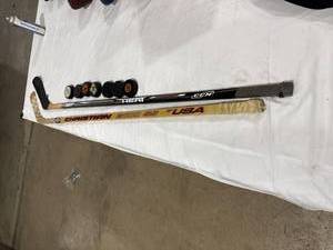 lot 1560 image: Hockey Sticks and Pucks Lot