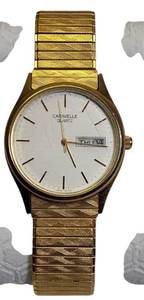 lot 50 image: Vintage Caravelle by Bulova Mens Gold Stretch Band Watch with DayDate Display.