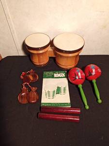 lot 33 image: Bongos, Morroccos, sticks, how to play banjo books and more
