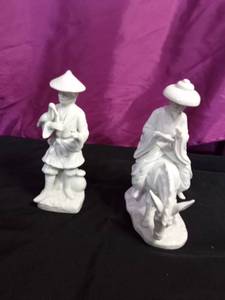 lot 63 image: Vintage Blanc de Chine man with bird porcelain figurine and a white porcelain Japanese man riding a donkey figurine