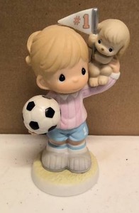 lot 125 image: Precious Moments Figurine A Winning Spirit Comes from Within Item#813044