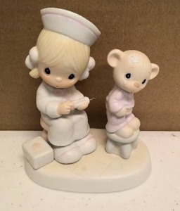 lot 155 image: Precious Moments Figurine love beareth all things Item#E-7158