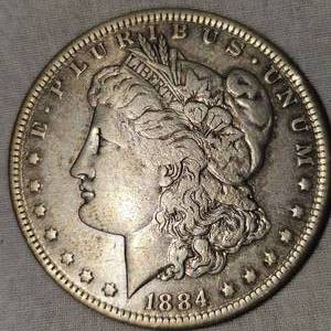 lot 32 image: 1884 O Morgan Dollar $1 Very Clean wToning