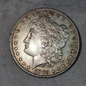 lot 57 image: 1885 Morgan Dollar $1 VF Plus wToning