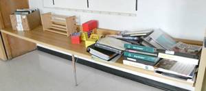 lot 9 image: Rm 207 - Counter full of binders, bookshelf etc