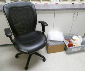 lot 198 image: ECFE - chair, bubble wrap and a small tote of coffee filters, napkins, pens