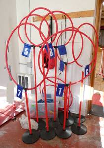 lot 258 image: GymS- frisbee golf stands and tub of rings