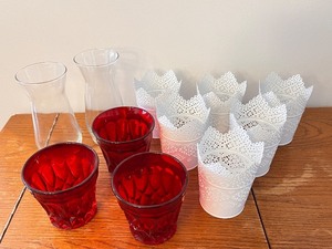 lot 39 image: Lot of 8 White Metal Lace Plant Holders, 3 Red Glass Cups, and 2 Clear Glass Vases