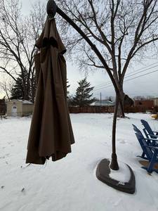 lot 413 image: Brown Cantilever Patio Umbrella with Weighted Base for Outdoor Shade