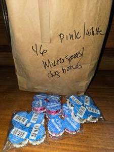 lot 7 image: Pink and white dog bone or dog paw ribbon (46)