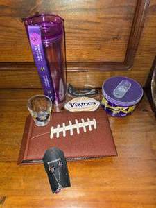 lot 119 image: Vikings lot, purple jewelry, water bottle, magnet, shot glass, picture book
