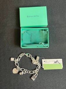 lot 6 image: Tiffany & Co. Sterling Silver Charm Bracelet with Box and Pouch - no signature T at clasp