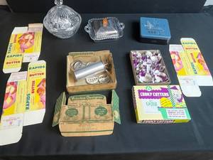 lot 50 image: Vintage Kitchenware Collection with Cookie Cutters, Butter Boxes, Glass Dishes, and Decorative Tin