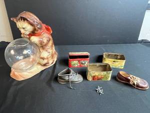 lot 56 image: Collection of Vintage Metal Tins, Baby Shoes, Jacks, and Cat with Fishbowl Figurine