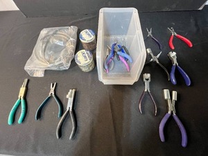 lot 215 image: Lot of Assorted Specialty Pliers, Washers, and Metal Rings with Storage Bin