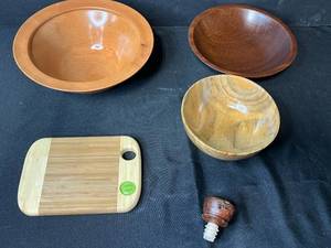 lot 277 image: Handcrafted Signed Wood Bowl Trio, Bamboo Cutting Board, and Wine Stopper Set