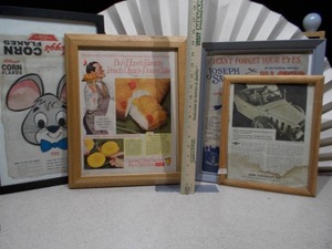 lot 61 image: The image displays a collection of framed vintage advertisements