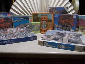 lot 81 image: This image displays a collection of various jigsaw puzzles