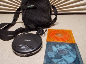 lot 86 image: This appears to be a Memorex MD6451 portable CD player along with a Case Logic carrying case and two CDs.