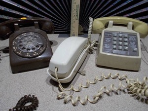 lot 110 image: The image features a collection of vintage telephones