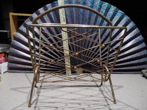 lot 137 image: This is a mid-century modern atomic brass magazine rack