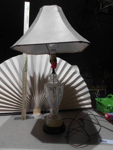 lot 151 image: This is a cut glass table lamp with a fabric shade.