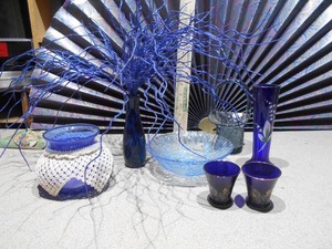 lot 162 image: The image displays a collection of various cobalt blue glass items,