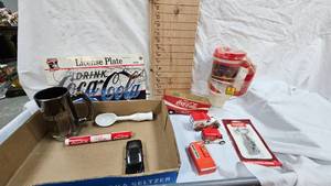 lot 87 image: Treasure Trove of Coca Cola Items-Mug, License Plate, bottle opener, and Misc