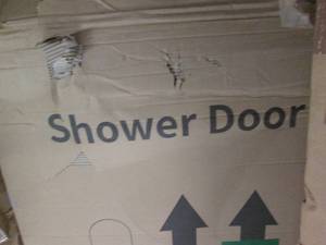 lot 102 image: Silver trimmed glass shower door...