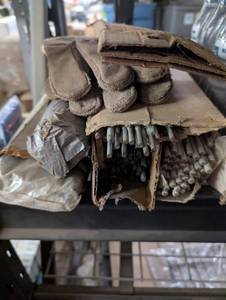 lot 132 image: Welding rods and a pair of welding gloves