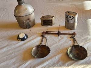 lot 32 image: Aladdin N-E C1 Hand Warmer, Luverne National Bank Mechanical Bank, Vintage Military Canteen, and Balance Scale