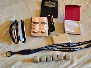lot 68 image: Pocket Juice Portable Charger, Hair Combs, Eyelash Set, Whiskey Stones, and Lanyard